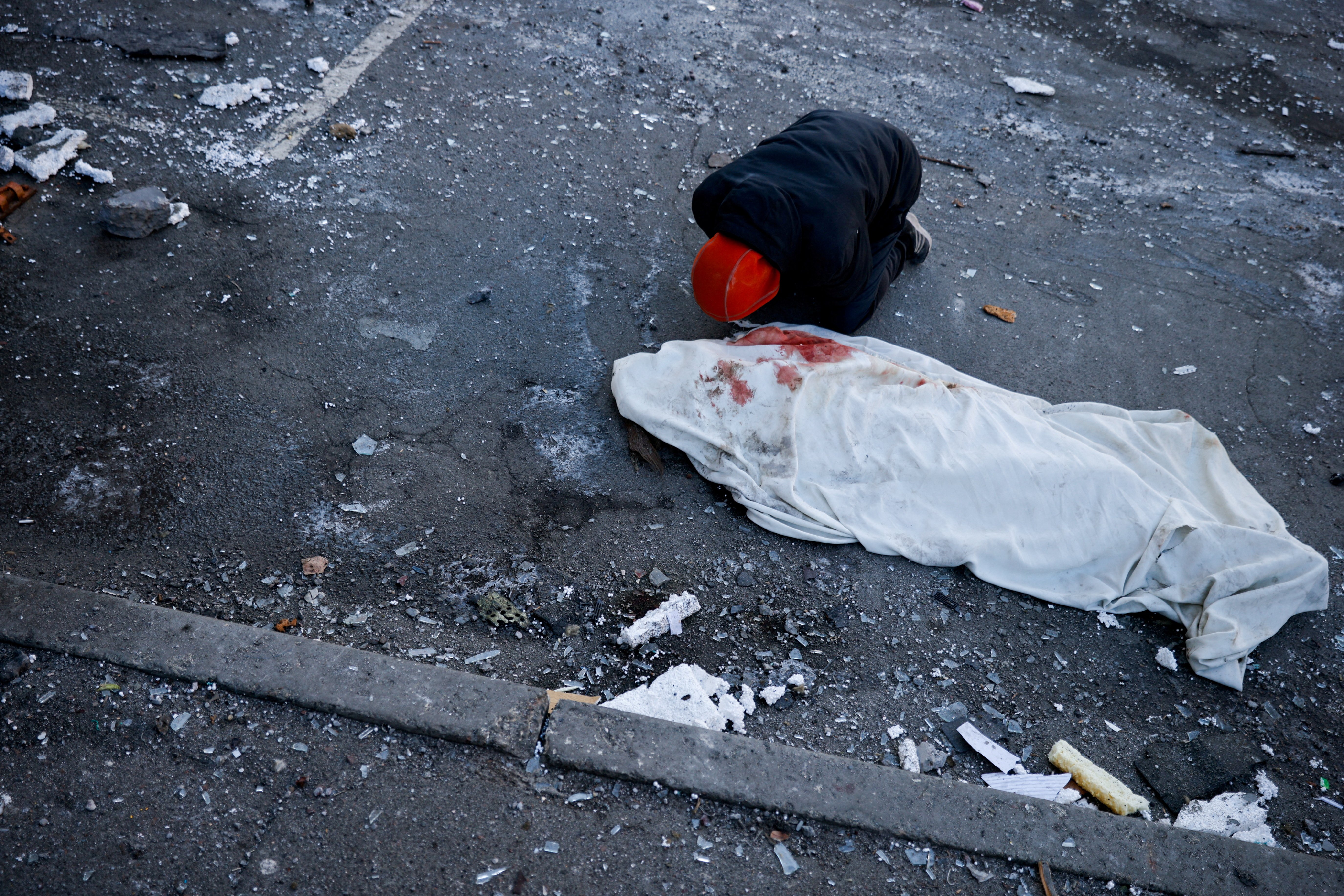 A man in Kyiv, Ukraine, mourns his mother, who was killed when an intercepted missile hit a residential building March 17, 2022. (CNS photo/Thomas Peter, Reuters)