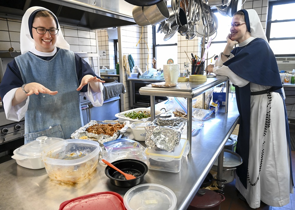 Sister Madeleine, left, works in the kitchen as she laughs with Sister Monica Marie on Jan. 15 at St. Anthony's Convent of the Sisters of Life in Catskill, New York. (CNS/The Evangelist/Cindy Schultz)
