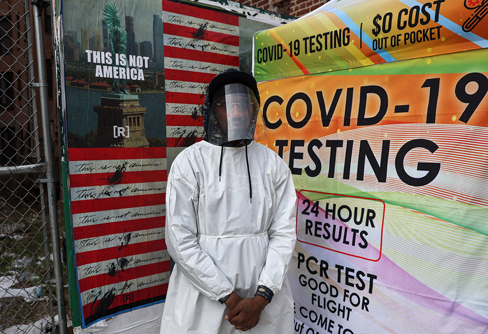 A health care worker in New York City stands for a photograph by a mobile COVID-19 testing center April 4. (CNS/Reuters/Shannon Stapleton)
