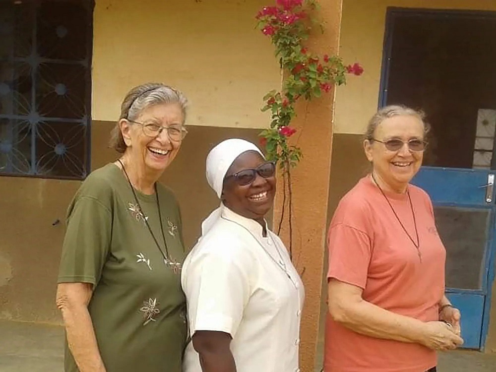 Three Marianite sisters (from left), Suellen Tennyson, Pascaline Tougma and Pauline Dourin, are pictured in an undated photo near the clinic where they serve in Yago, Burkina Faso. (CNS/Courtesy of the Marianites of the Holy Cross)