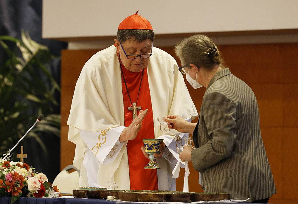 Cardinal João Braz de Aviz is assisted by Comboni Sr. Gabriella Bottani during a May 3 Mass with superiors of women's religious orders at the plenary assembly of the International Union of Superior Generals in Rome. (CNS/Paul Haring)