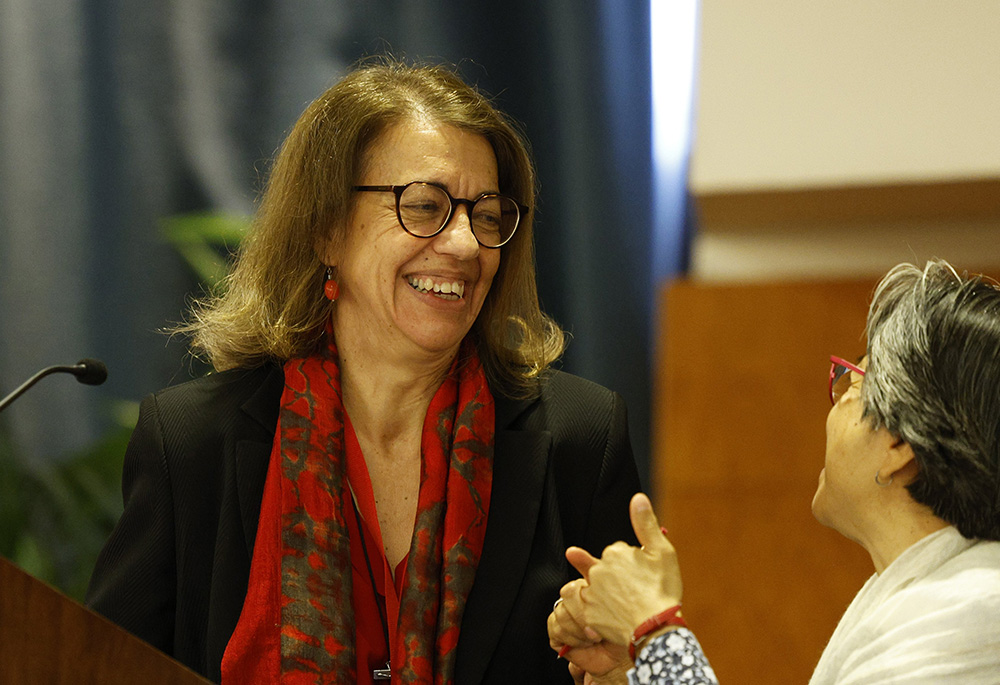 Sr. Nurya Martinez-Gayol Fernández, left, speaks with Sr. Aurora Torres Hernandez as she gives a talk May 3 during the plenary assembly of the International Union of Superior Generals in Rome. (CNS/Paul Haring) Hernandez 