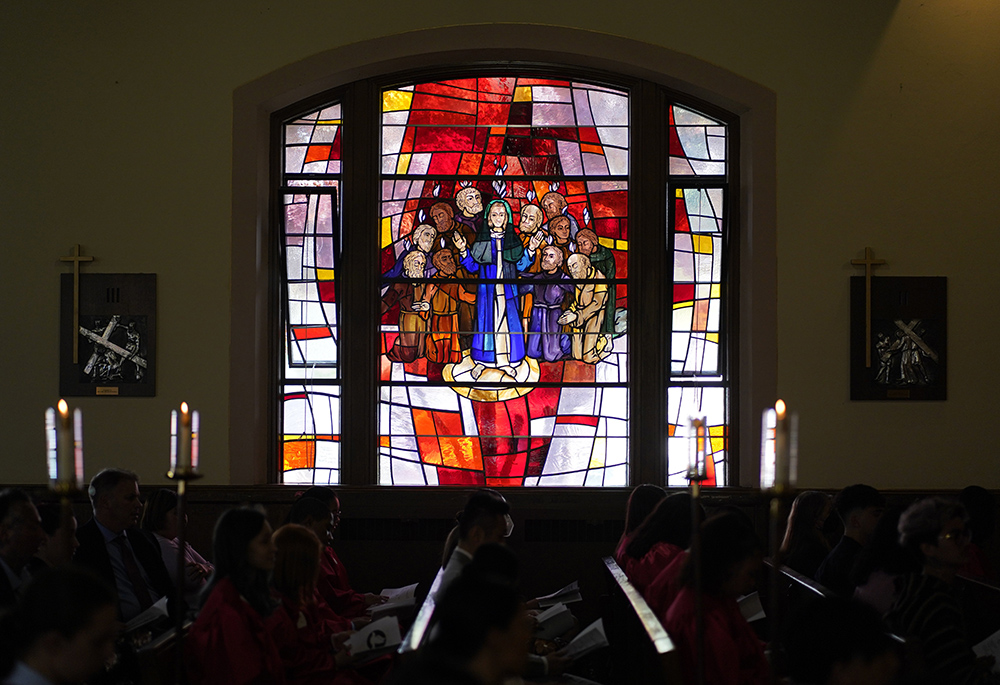 A stained-glass window depicting the descent of the Holy Spirit upon Mary and the apostles is seen during a confirmation Mass May 5 at Holy Family Church in Queens, New York. (CNS/Gregory A. Shemitz)