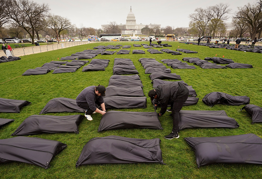 Body bags are placed on the National Mall in Washington near the U.S. Capitol on March 24. (CNS/Reuters/Kevin Lamarque)