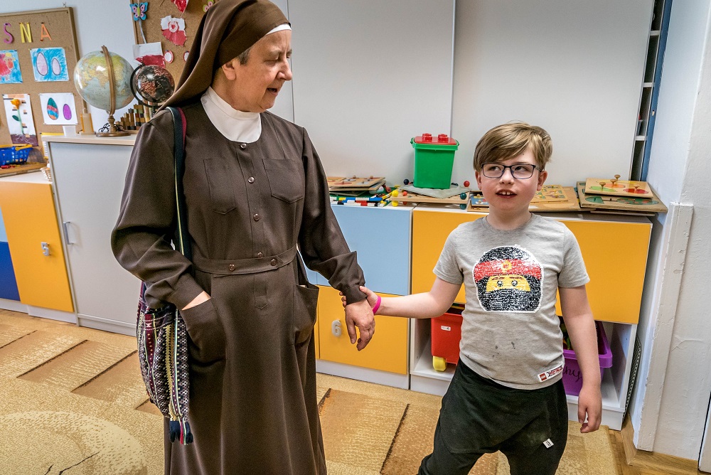 Sister Angelica of the Franciscan Sisters Servants of the Cross talked with a visually impaired refugee student from Ukraine at their monastery in Laski, Poland, on May 20. (CNS/Lisa Johnston)