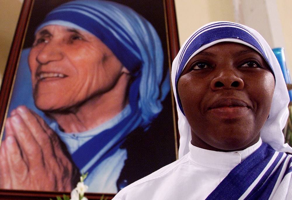 A member of the Missionaries of Charity is pictured in a file photo near an image of St. Teresa of Kolkata during Mass at the cathedral in Managua, Nicaragua. The religious order has been expelled from Nicaragua. (CNS/Reuters/Oswaldo Rivas)