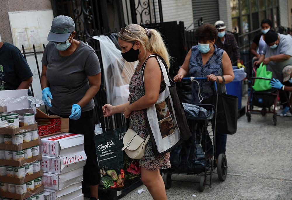 People receive food donations July 13 from a food pantry outside a church in the Bronx borough of New York City. (CNS/Reuters/Shannon Stapleton)