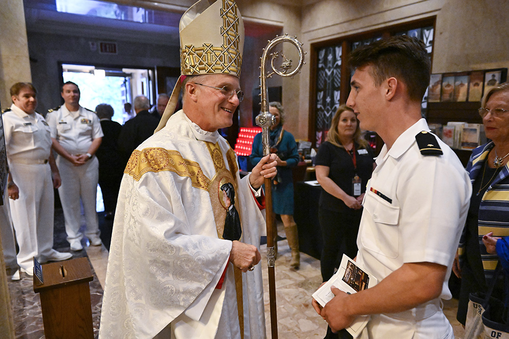 Archbishop Timothy Broglio of the U.S. Archdiocese for the Military Services greets a U.S. Naval Academy cadet midshipman Oct. 2 after the annual Sea Services Pilgrimage Mass at the National Shrine of St. Elizabeth Ann Seton in Emmitsburg, Maryland. (CNS/