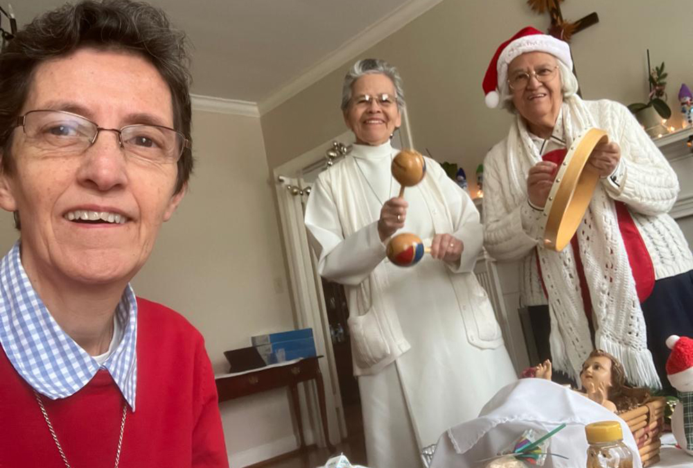 Srs. Edith Lugo, Teresa Aguiñaga, and Marta Lucía Tobón sing carols to the child God at Christmas. (Courtesy of Marta Tobón)