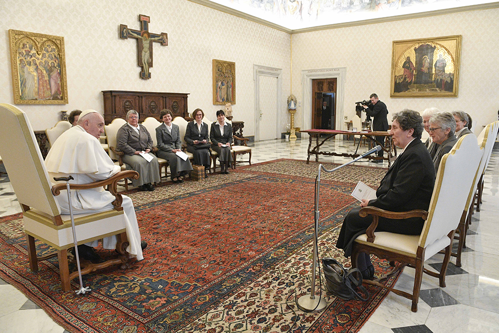Pope Francis sits with a group of women in a semicircle