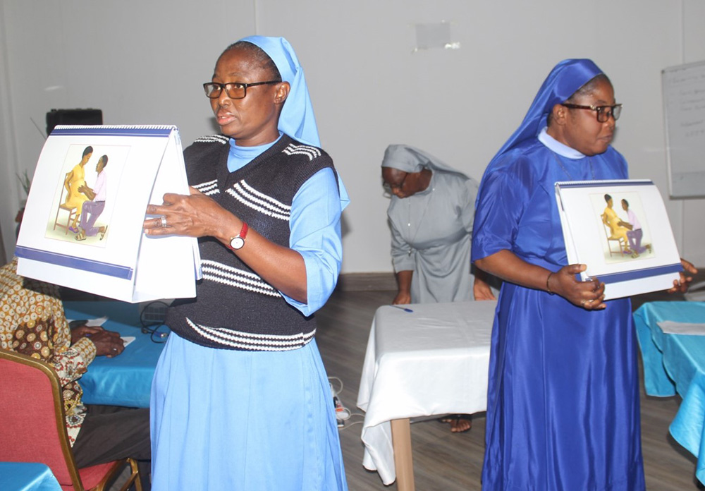 Mary Immaculate Sr. Stephany Ayomah, left, and Daughter of Mary Mother of Mercy Sr. Agatha Chiamaka, a midwife at Good Shepherd Health Centre at Tuna in the Damongo Diocese, demonstrate how to use flipcharts during one of a June trainings in Tamale, Ghana. (Courtesy of Francis Monnie)