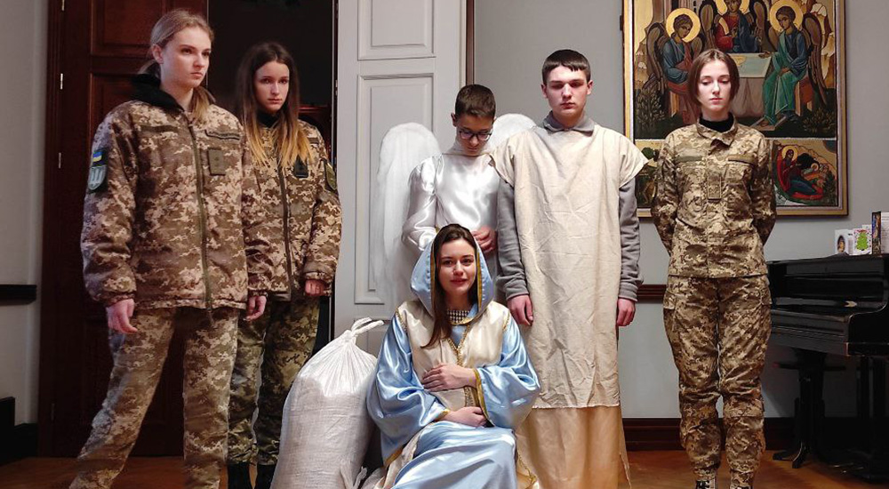 In Ukraine, a Christmas tradition involves young people performing Nativity scenes in people's homes. In this performance at the Basilian sisters' monastery, young people portray Joseph and Mary as refugees returning to Bakhmut for Jesus' birth; they are accompanied by volunteers and soldiers. Many Nativity scenes came to the monastery, and all of them covered the war. (Courtesy of Yeremiya Steblyna)