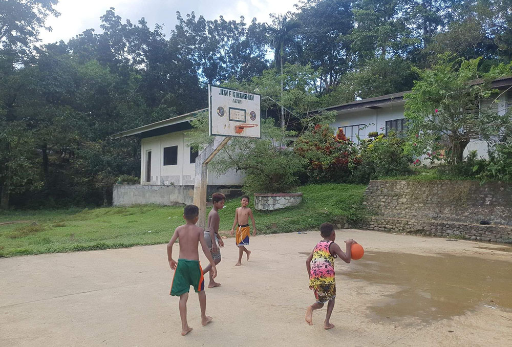Children play basketball at the Aeta Resettlement and Rehabilitation Center in Subic, Zambales, Philippines. Most of the facilities are located in Phase 4 of the village. (Oliver Samson)