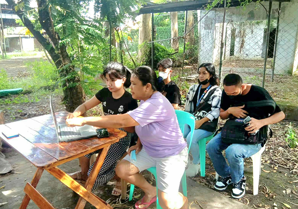 Sr. Helen Grace Marcelo, a member of the Sisters of the Good Samaritan (in purple), and Desirie Tiberio (in black), park rehabilitation coordinator, are pictured at the park they are reviving in Bacolod, Negros Occidental, Philippines, with other volunteers. (Courtesy of the Sisters of the Good Samaritan)