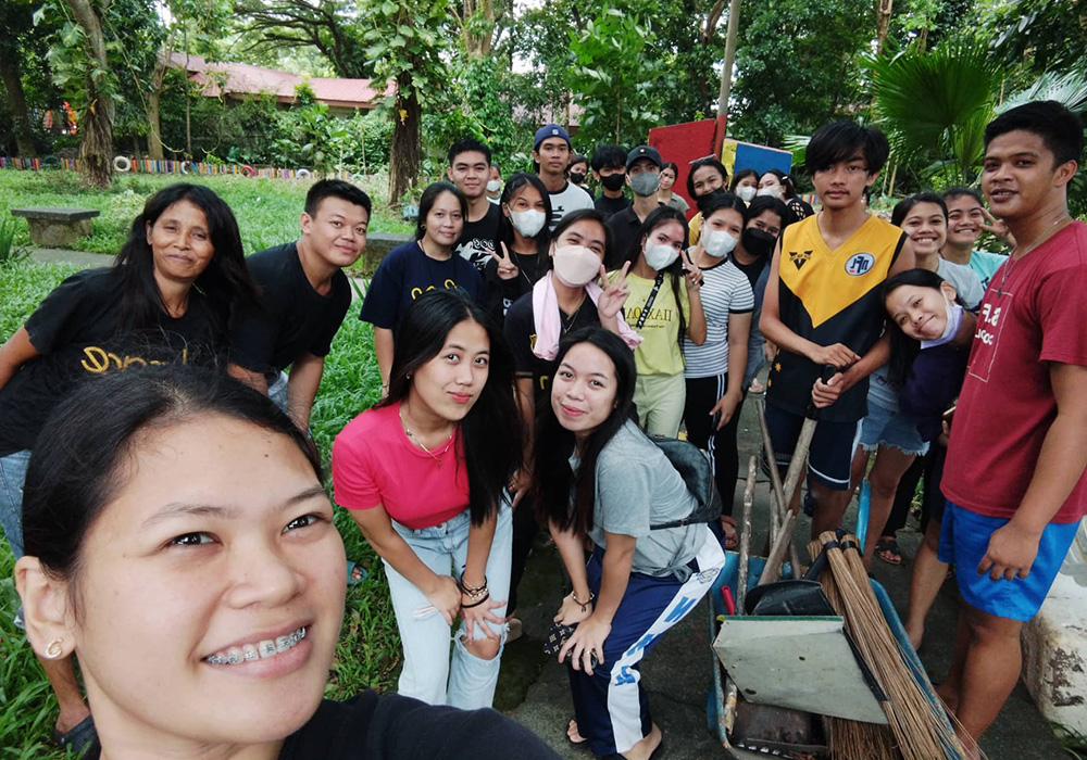 Volunteer students pose for a photo on a cleaning day at the park they are reviving in Bacolod, Negros Occidental, Philippines. (Courtesy of the Sisters of the Good Samaritan)