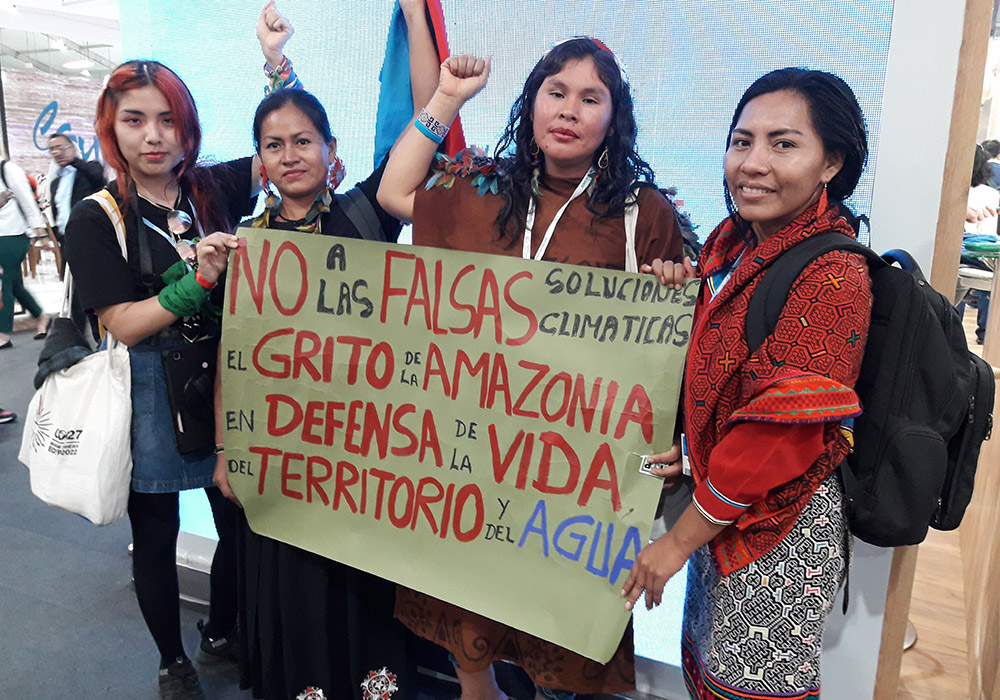 En la COP27 de Sharm el-Sheikh, Egipto, un grupo de jóvenes de Perú con una pancarta de protesta, exigiendo: "No a las falsas soluciones climáticas, el grito de la Amazonia clama en defensa de la vida, del territorio y del agua." (Cortesía de Ana María Siufi)