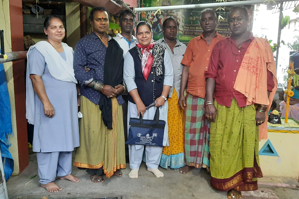 : Fatima Sr. Roseline Jose, left, and Sr. Saly Joseph, center, members of the Sisters of Our Lady of Fatima of Pune, pose with a group of older members of the transgender community in Bengaluru, India. 