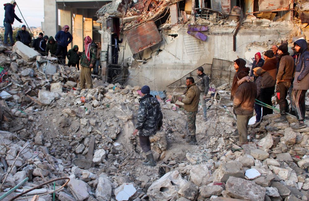 Earthquake survivors gather on the rubble of a destroyed building in Aleppo, Syria, on Feb. 7. 