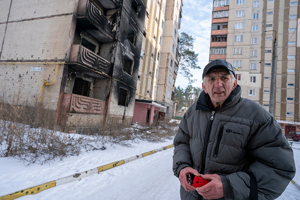 Basil Knutarev stands in front of his apartment building in Irpin, Ukraine, that was destroyed by Russian artillery in the early days of the invasion. All the residents had evacuated and nobody was injured in the shelling. (Gregg Brekke)