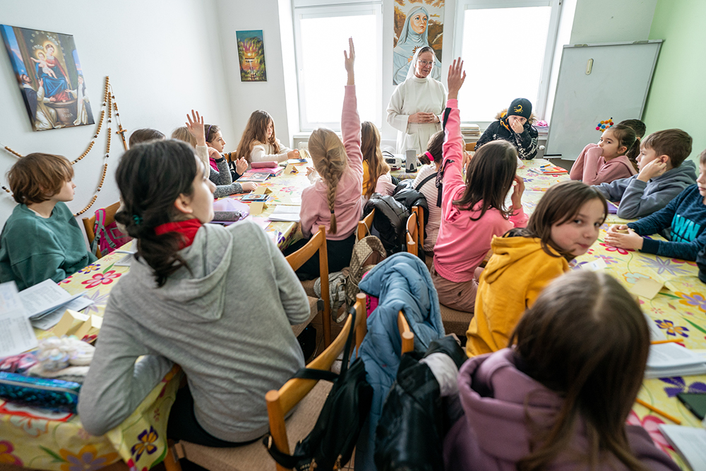 Sr. Lydia Timkova of the Dominican Sisters of Blessed Imelda teaches a catechism class in Mukachevo, Ukraine, in February. Her students include new arrivals from other parts of Ukraine displaced during the war. The Dominican sisters are originally from neighboring Slovakia but have long experience in Mukachevo. Since the war's beginning, Timkova has traveled to eastern Ukraine at least three times to deliver humanitarian aid to areas hardest hit by the war. (Gregg Brekke)