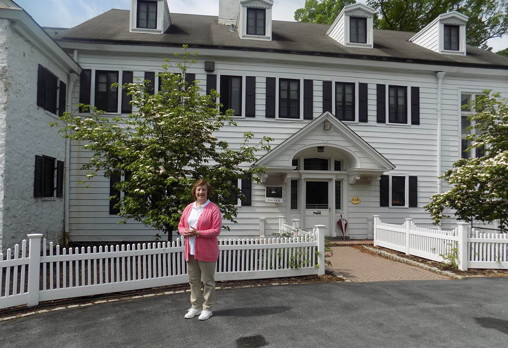 Dominican Sr. Jean Graffweg stands in front of House on the Hill in Goshen, New York. The facility, which now hosts a Head Start program serving the children of migrant farmworkers, recently celebrated its 50th anniversary. Graffweg has worked there 42 years. (Courtesy of Sisters of St. Dominic of Blauvelt, New York)