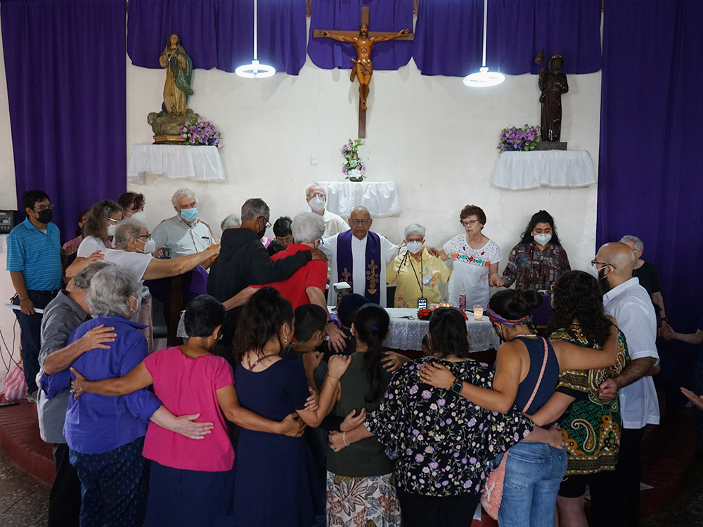 Members of a delegation to El Salvador and Honduras sponsored by the SHARE Foundation and the Leadership Conference for Women Religious pray during Mass celebrated by Honduran Jesuit Fr. Ismael Moreno Coto, known as Padre Melo, on Dec. 11, 2022. (SHARE Foundation/Mark Coplan)