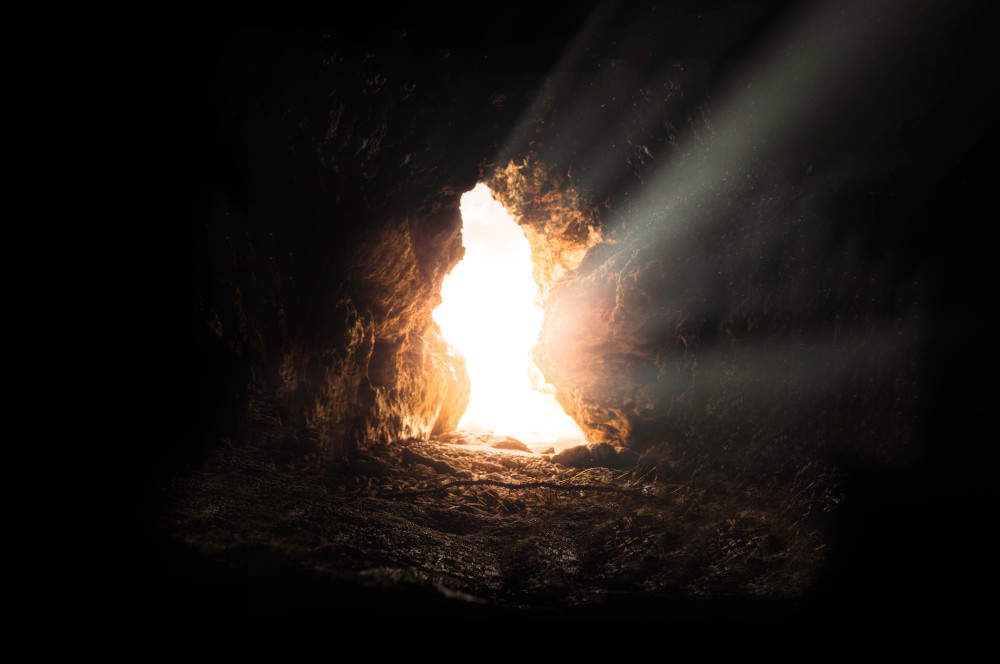 Light shining into a dark cave (Unsplash/Bruno Van Der Kraan)