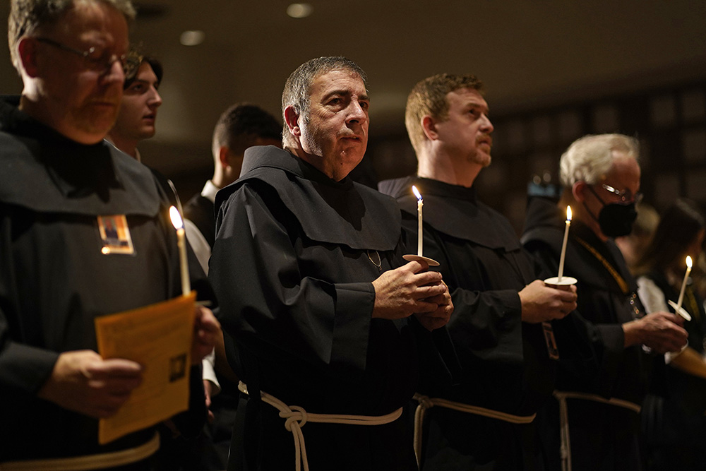 Members of the Franciscan Brothers of Brooklyn, New York, hold candles during a Mass marking the feast of St. Francis of Assisi at Franciscan-run St. Anthony's High School in South Huntington, New York, Oct. 4, 2022. The friars renewed their vows to consecrated ministry during the liturgy. (CNS/Gregory A. Shemitz)