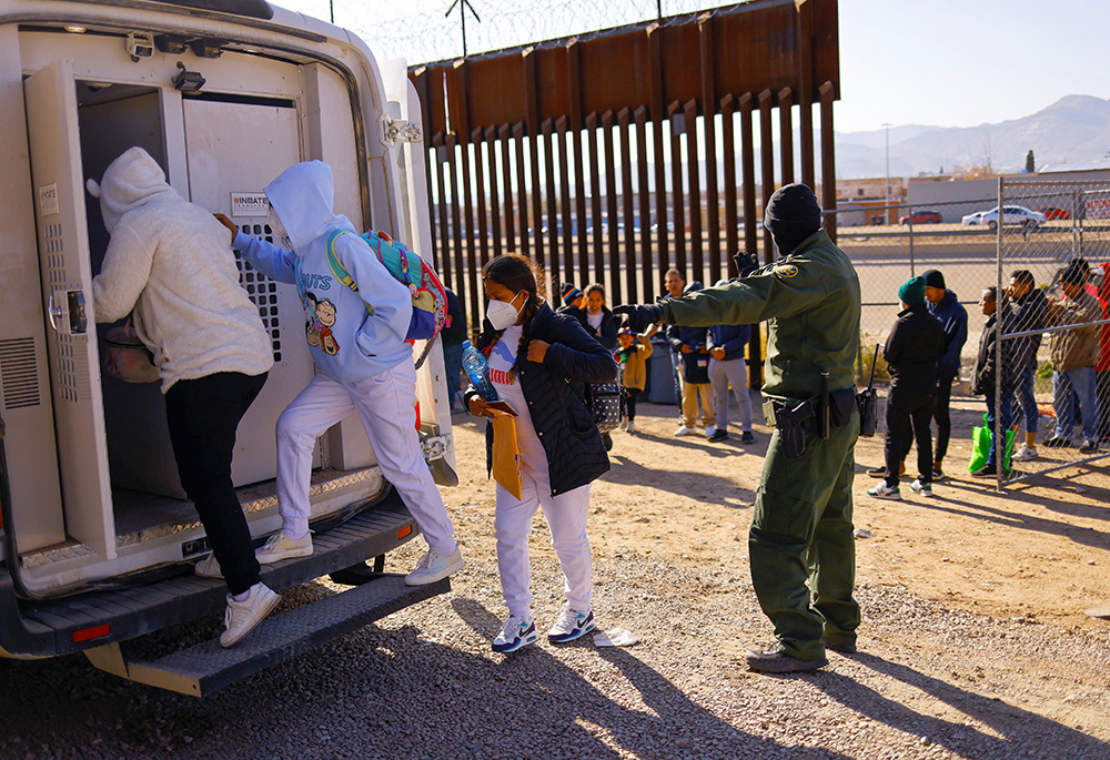 Migrants detained by U.S. Border Patrol agents after crossing into the United States from Mexico to request asylum get in a vehicle to be transferred to a detention center Dec. 19, 2022, in El Paso Texas. (OSV News/Reuters/Jose Luis Gonzalez)