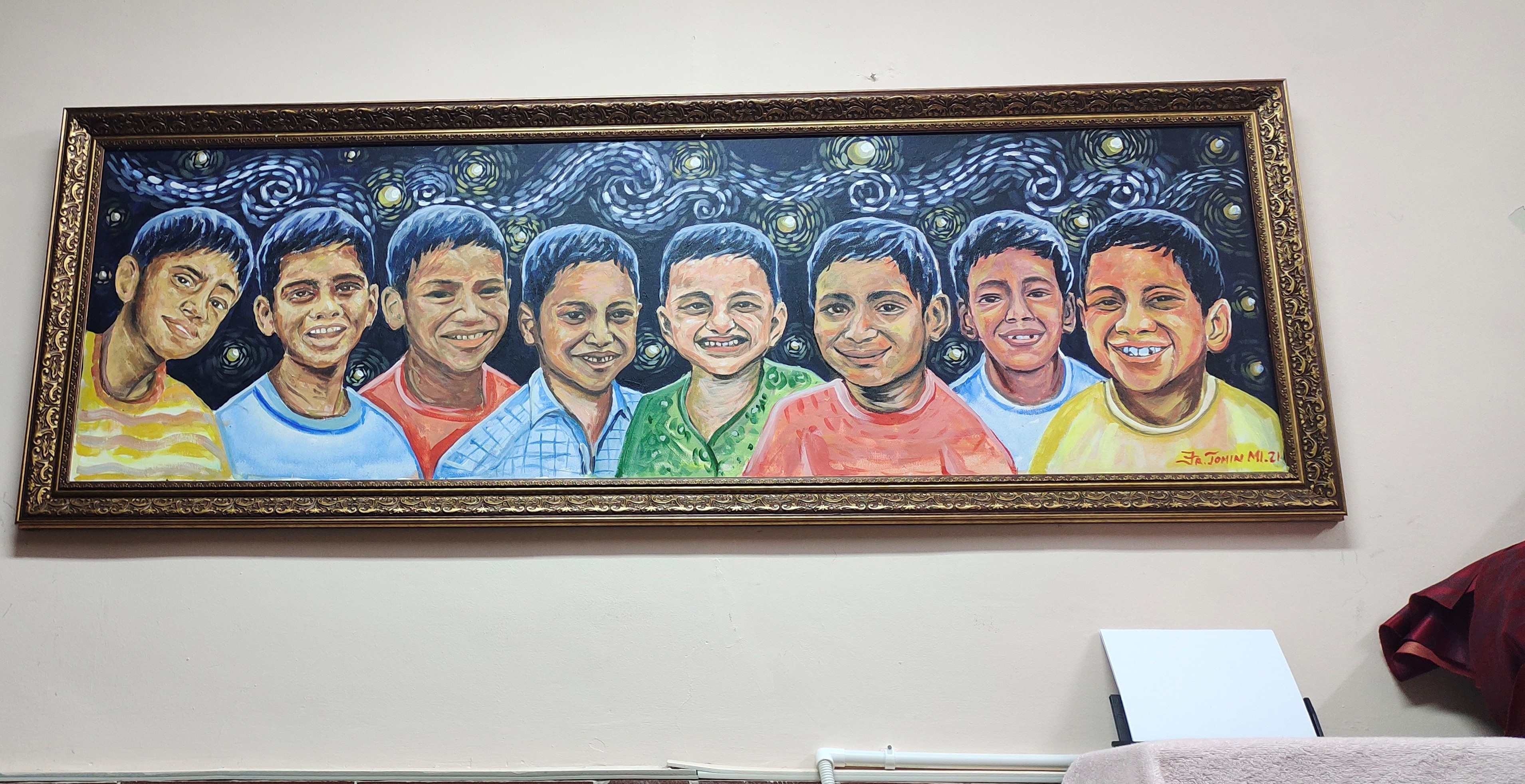 A large painting of a row of boys' heads, depicting boys who have lived at the center.