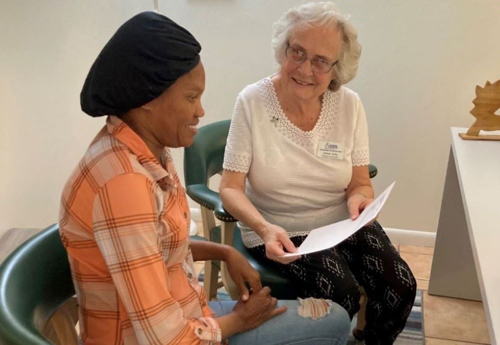 1.	Sr. Judith Dohner helps a Haitian immigrant woman with paperwork. (Courtesy of Judith Dohner)
