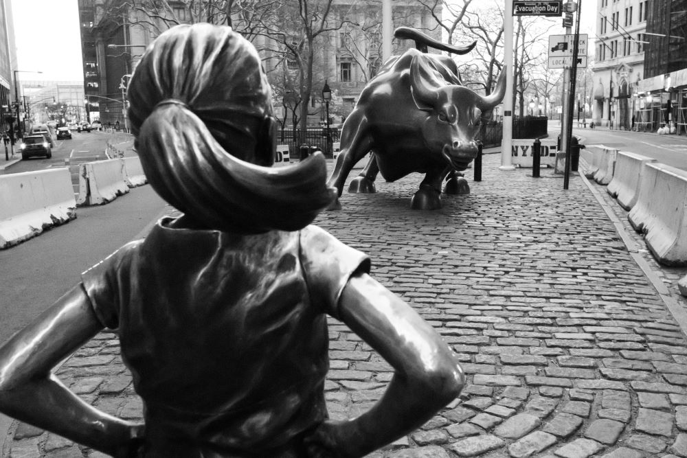 Fearless Girl statue, which depicts a girl with a pony tail and hands on hips, faces the Charging Bull statue in New York's Financial District.