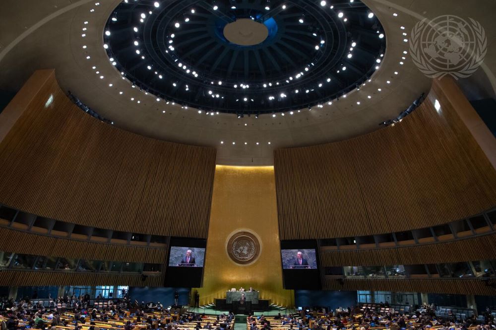A wide view of the United Nations General Assembly Hall in New York City as Secretary-General António Guterres (on screens) addresses the opening of the 66th session of the Commission on the Status of Women in March 2022. 