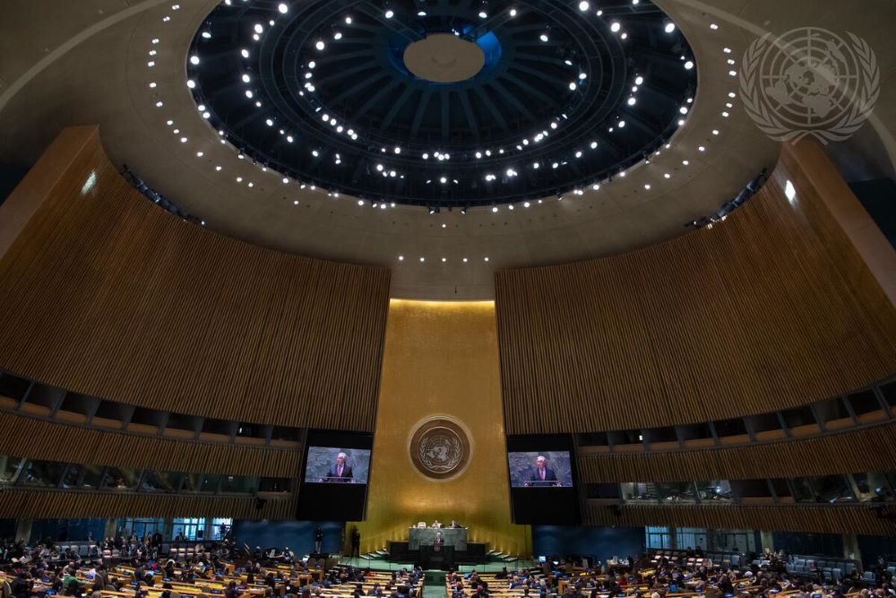 A wide view of the United Nations General Assembly Hall in New York City as Secretary-General António Guterres (on screens) addresses the opening of the 66th session of the Commission on the Status of Women in March 2022.