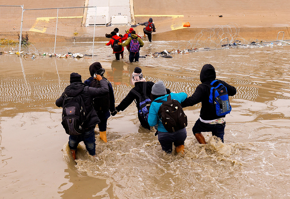 Asylum-seeking migrants are pictured crossing the Rio Bravo river from Ciudad Juarez, Mexico, the border between the United States and Mexico, to request asylum Jan. 2 in El Paso, Texas. (OSV News/Reuters/Jose Luis Gonzalez)