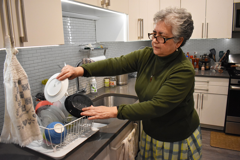 Alba Luz Mejia Solis, novice with the Franciscan Sisters of Allegany, washes the dessert dishes at the InterCongregational Collaborative Novitiate in Chicago. (Julie A. Ferraro)