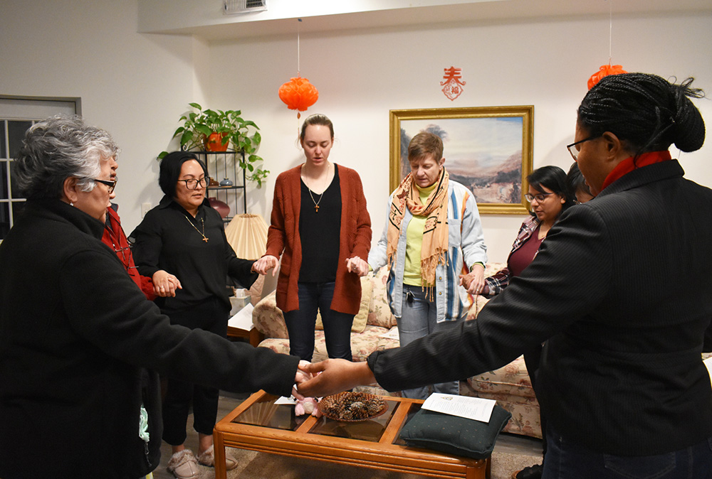 At the conclusion of evening prayer at the InterCongregational Collaborative Novitiate in Chicago, the novices and the codirectors gather to simultaneously recite the Lord's Prayer, each in her native language. (Julie A. Ferraro)