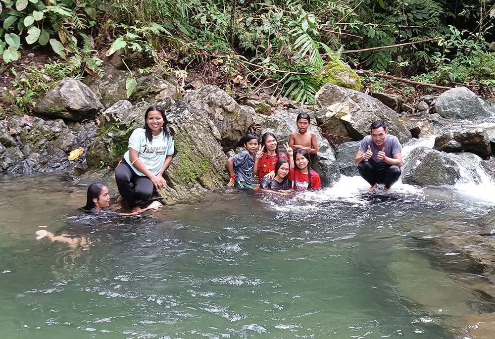 The author and her companions stopped for a quick swim in the river stream pictured in this photo, located near the road of a mountain village in Nanga Nangan, Philippines. (Courtesy of Marjorie Guingona)