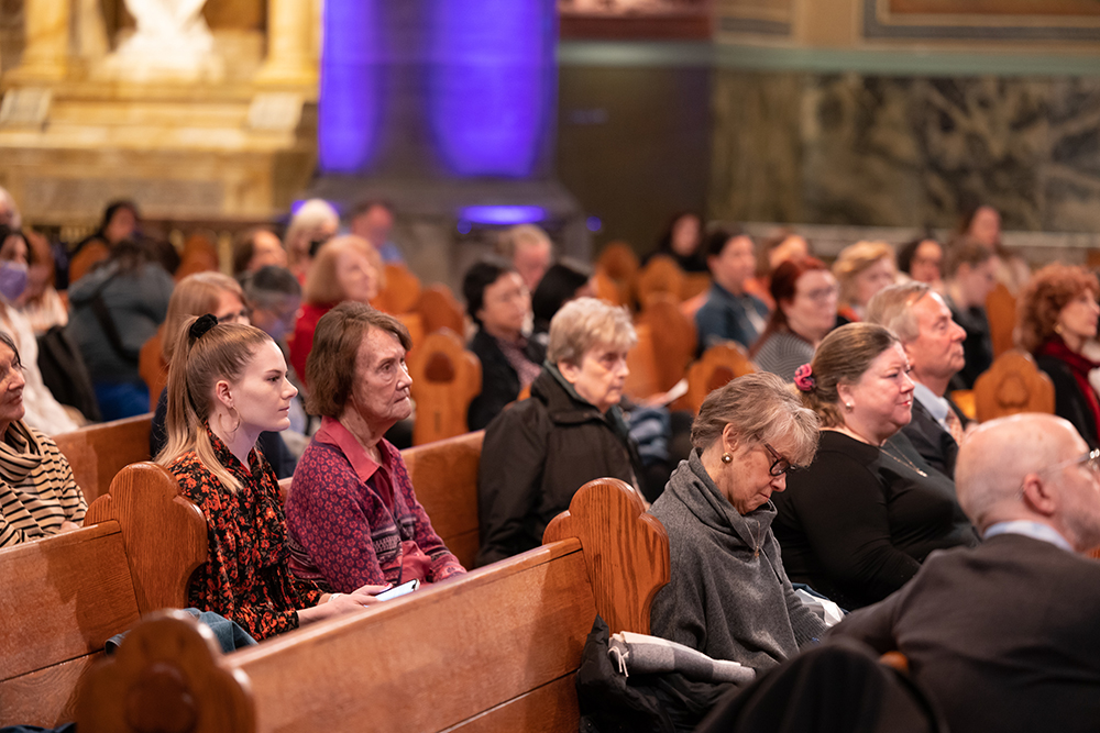 Audience members listen to Sr. Nathalie Becquart at a March 28 lecture at the Church of St. Paul the Apostle in Manhattan. During a question-and-answer period, audience members asked Becquart about the challenges of changing a highly hierarchical, male-dominated institution like the Catholic Church. "We need to face the tension. That is what we're learning," she replied. (Fordham University/Leo Sorel)