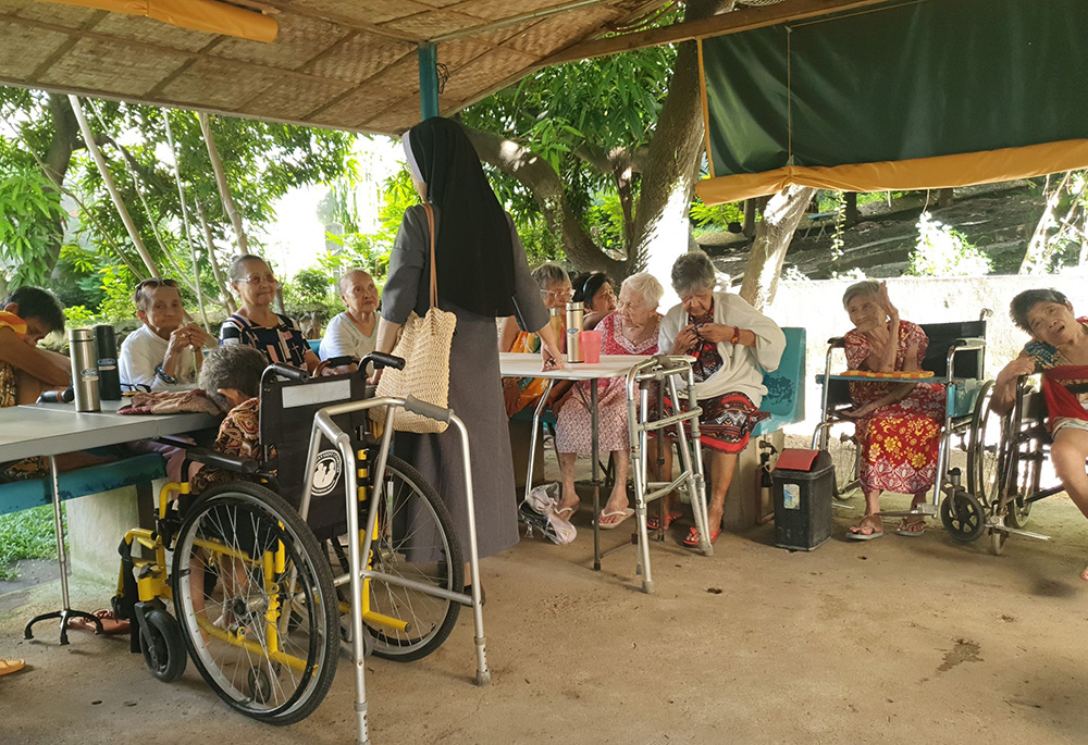 Residents of Mary Mother of Mercy Home for the Elderly and Abandoned in San Pedro, Laguna, Philippines, gather in the home's outdoor hut to recite the Divine Mercy prayer and the rosary. They also watch TV there. (Oliver Samson)