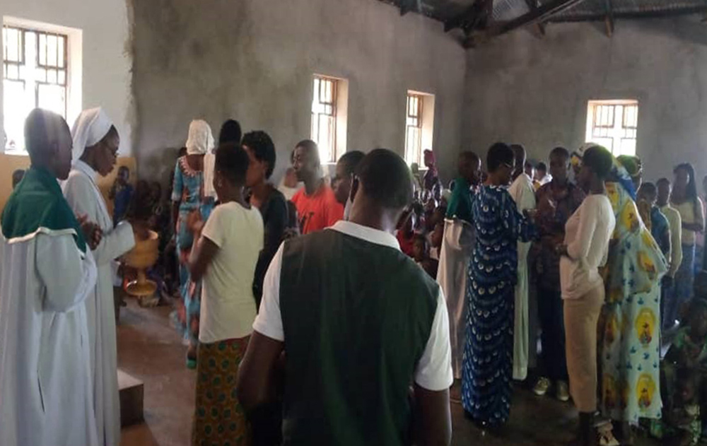 People gather with sisters after a church service in the town of Kiwanja, Rutshuru, Democratic Republic of Congo. (Stephano Kambale)