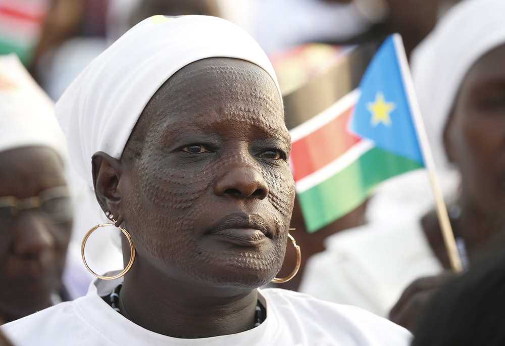 A woman waits for the start of Pope Francis' celebration of Mass at the John Garang Mausoleum in Feb. 5 in Juba, South Sudan. (CNS/Paul Haring)