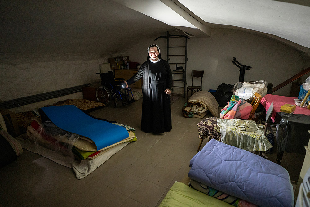 Basilian Sr. Anna Andrusiv shows visitors how sisters prepared basement quarters in Lviv, Ukraine, for visitors heading west to Poland and other countries during the first six months of the Russia-Ukraine war. The Sisters of the Order of St. Basil the Great also used the basement as a shelter when air-raid sirens went off. (GSR photo/Gregg Brekke)