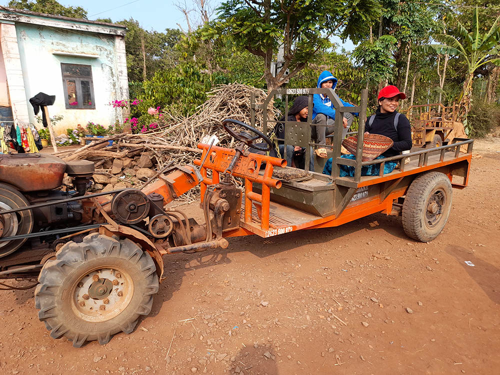 Locals use motor vehicles to carry people, fertilizers and agricultural tools to their farms in the Vietnam Central Highlands. Others who can't afford a vehicle walk to their farms. (Joachim Pham)