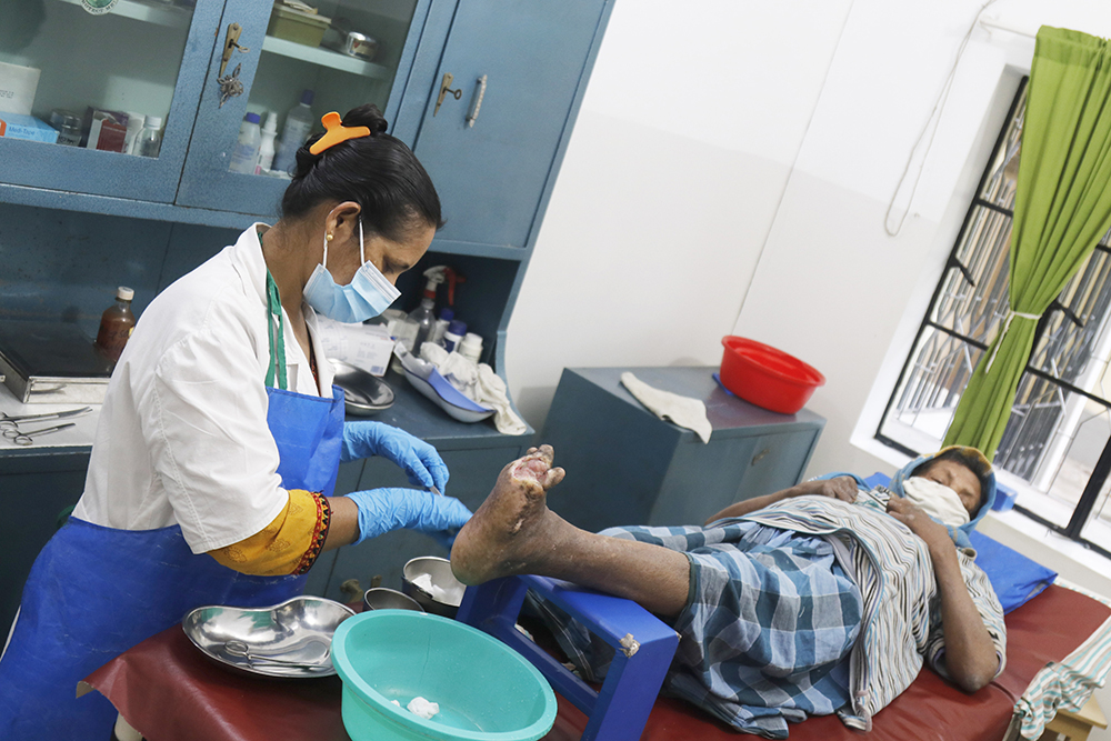 A nurse treats a patient at Damien Hospital's leprosy center in Khulna, Bangladesh. (Uttom S. Rozario)