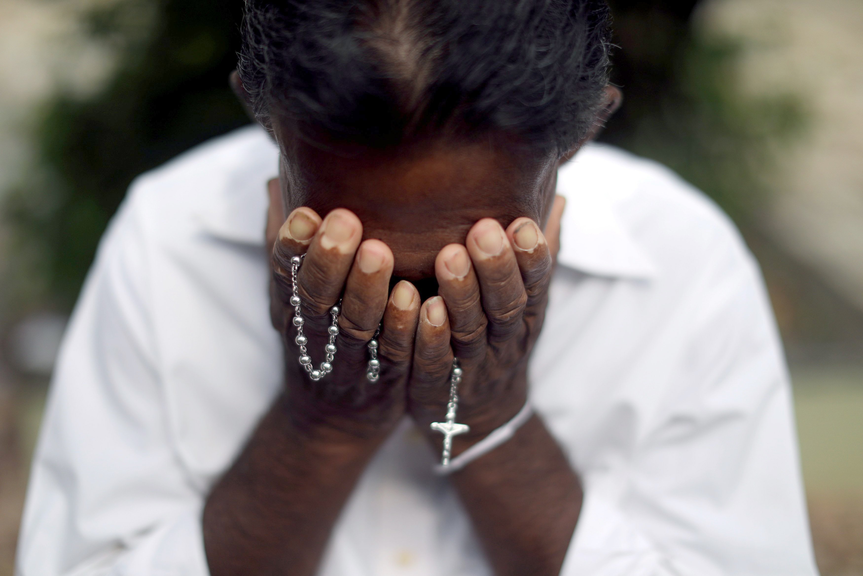 A person mourns near the grave of a suicide bombing victim at Sellakanda Catholic cemetery April 23, 2019, in Negombo, Sri Lanka. (CNS/Reuters/Athit Perawongmetha)