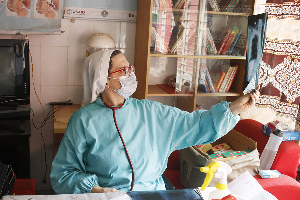 Sr. Roberta Pignone examines a patient's X-ray at Damien Hospital in Khulna, Bangladesh. (Uttom S. Rozario)