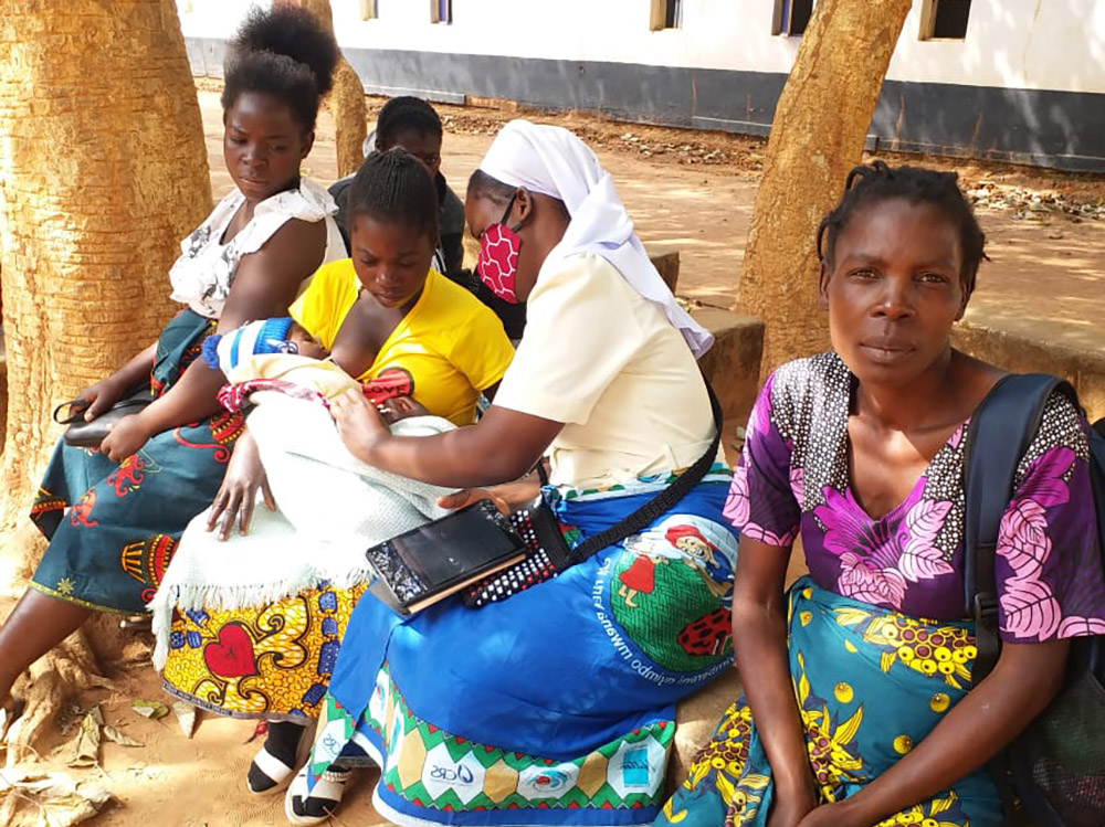 Mercy Sr. Christabel Kazembe interacts with mothers and their children during one of her community outreach programs with Strengthening the Capacity of Religious Women in Early Childhood Development (SCORE-ECD) in Zambia. (Courtesy of Christabel Kazembe)