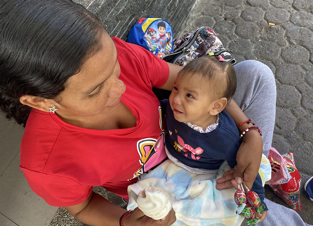 Andreína González, of Venezuela, plays with her 10-month-old daughter, Yulianis, in downtown San José, Costa Rica, March 31. Like many Venezuelan migrants, González traveled through Costa Rica in March with two children, hoping to make into the United States, fleeing the economic situation in her native country. (GSR photo/Rhina Guidos)
