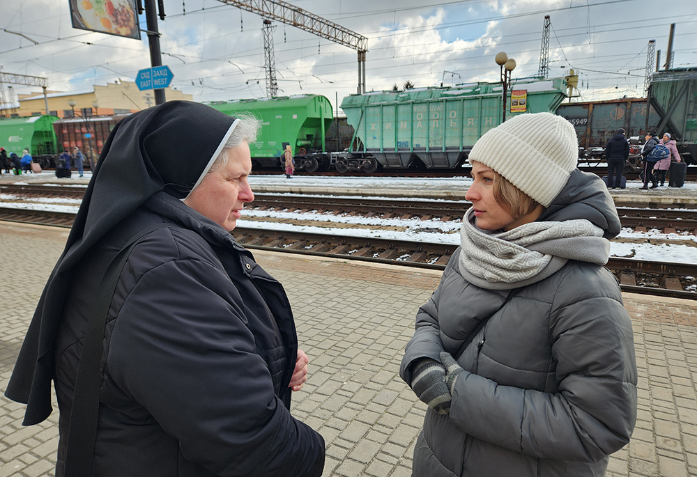 Dominican Sr. Edita Vozarova and a translator, Natalia Kommodova, herself displaced first in 2014 and then in 2022, see Chris Herlinger and Gregg Brekke off on the train platform in Mukachevo, Ukraine. (GSR photo/Chris Herlinger)